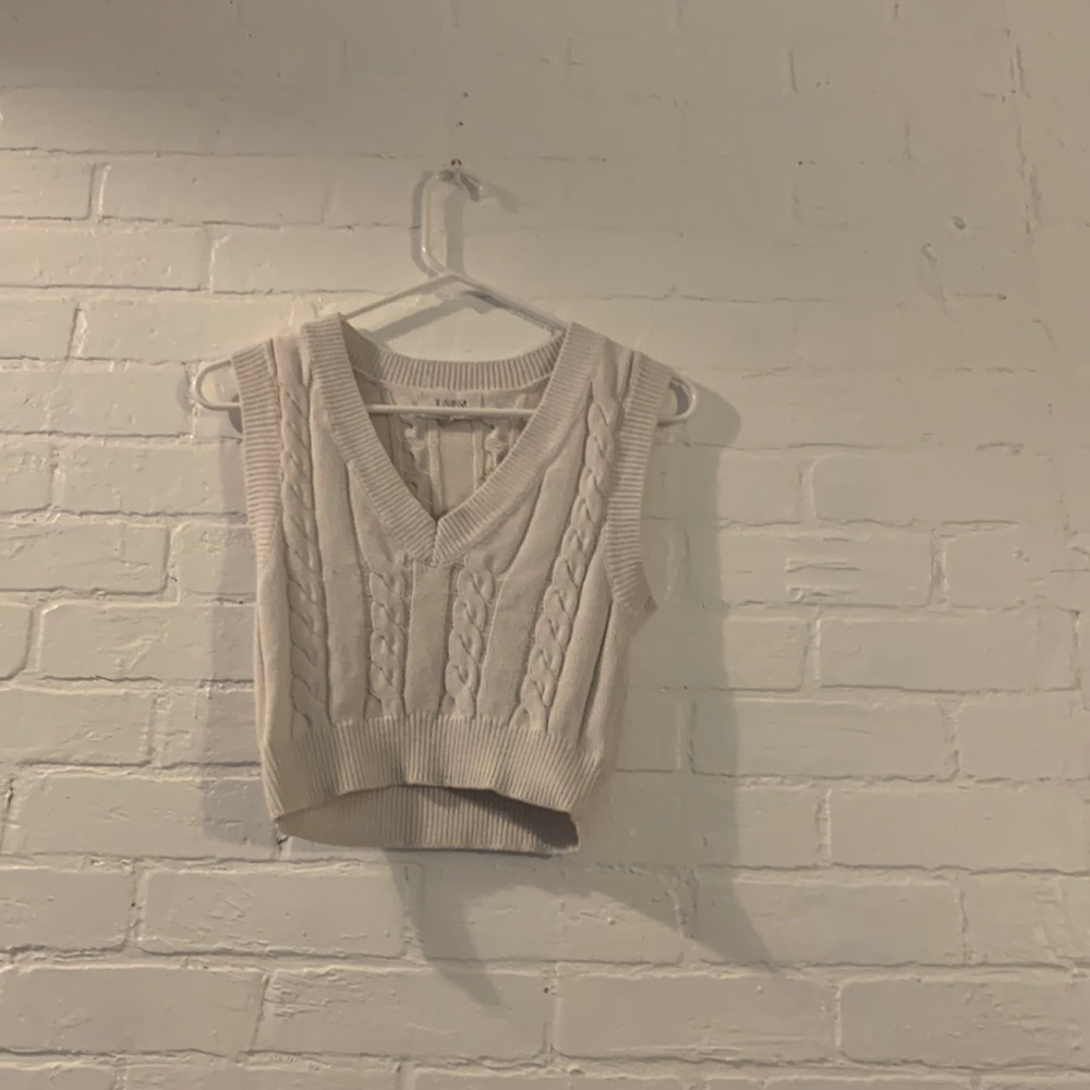 we are selling a white sweater vest originally from jacks surf shop